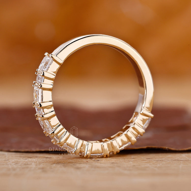 Elegant baguette cut wedding band in yellow gold.