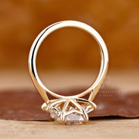 Emerald cut engagement ring with three stone design for added brilliance.