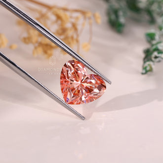A pink diamond shaped like a heart with 4 carat weight and lab grown brilliance.