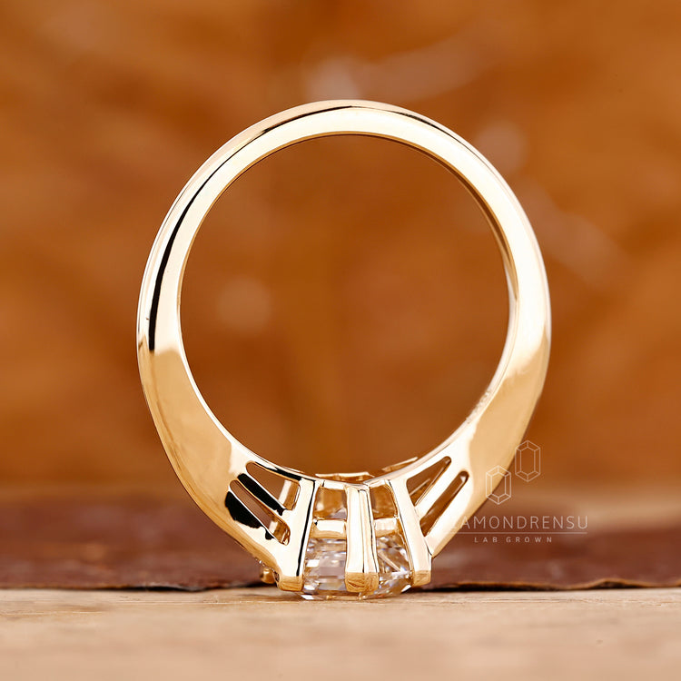 V prong setting hexagon step cut engagement ring.