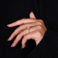 Milgrain setting ring with marquise center and round side diamonds.