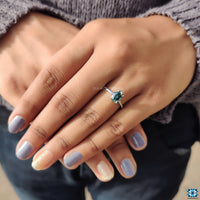 Moissanite oval ring in solitaire setting with 4 claw prongs.