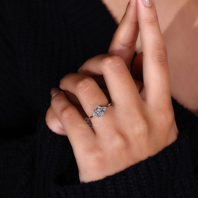 Round Side Stone Engagement Ring with an elegant oval center.