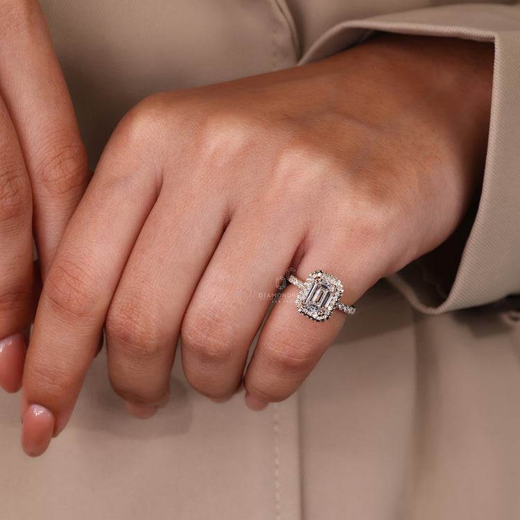 Double claw prong engagement ring with emerald halo.