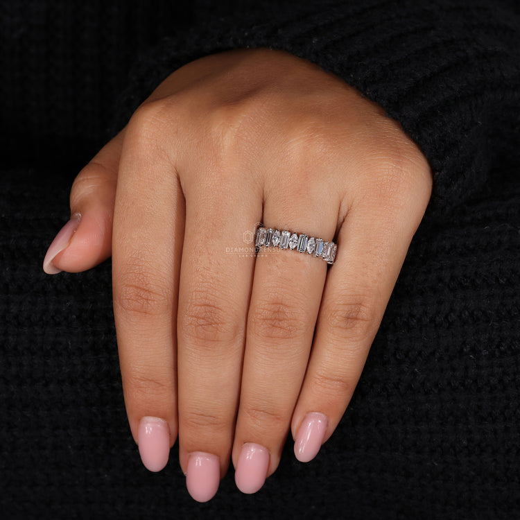 V-shaped prong setting for a unique wedding band style.