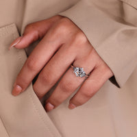 Diamond ring with triangle side stones and knife edge shank.