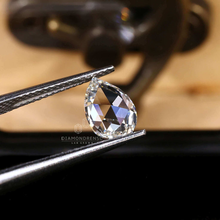 Loose lab grown diamond featured in pear rose cut for custom rings.