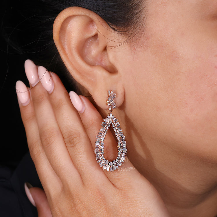 Custom rose gold earrings featuring baguette shape diamonds