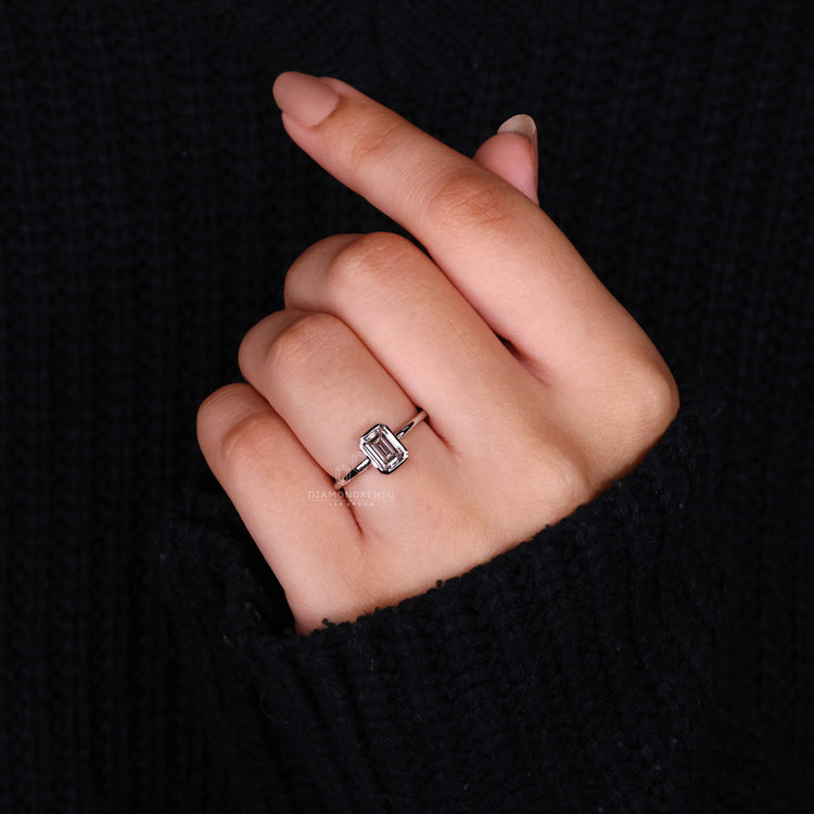 White Gold Ring with an emerald cut diamond for luxury.