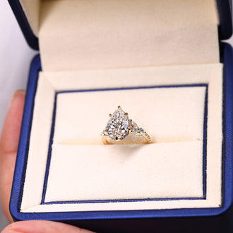 Hidden halo ring featuring pear cut diamond in yellow gold setting.