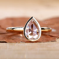 Sparkling pear shaped diamond ring for timeless beauty.