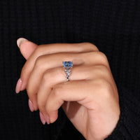 White gold engagement ring with a stunning blue diamond center and a 4 prong claw setting.