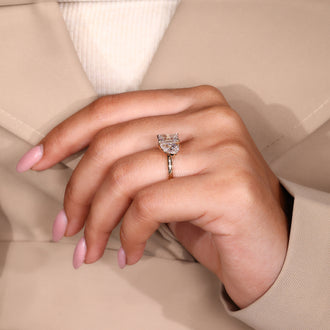 Handmade ring showcasing pear and emerald cut stones.