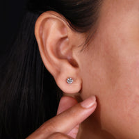 Dazzling diamond earrings round for timeless style.