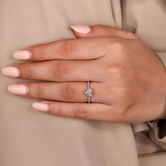 V shaped prong ring holding heart shaped diamond securely in place.