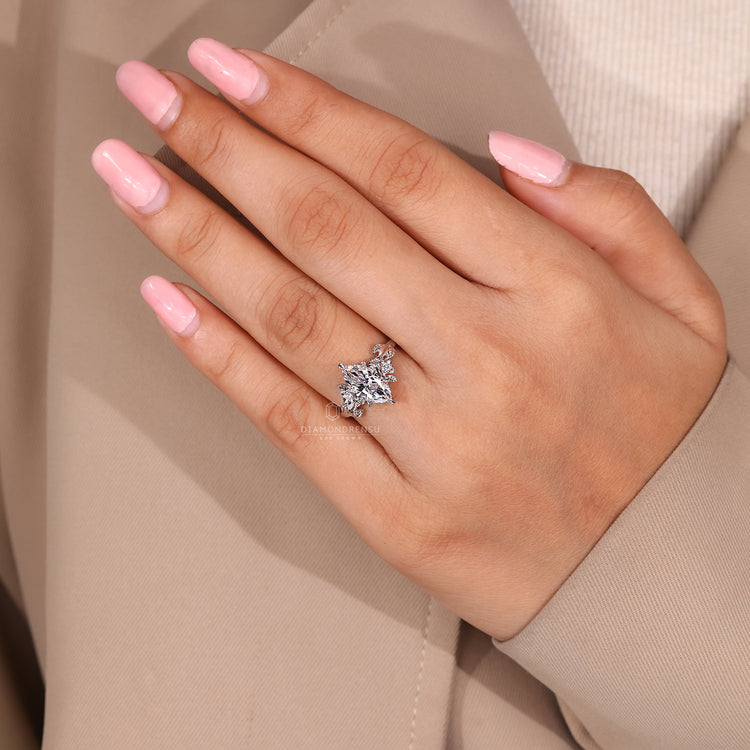 Unique engagement ring with marquise diamonds and round side stones, set in a beautiful band.