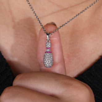 Unique sport pendant featuring Bowling Pin charm and prong set diamonds.