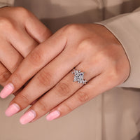 Nature-inspired engagement ring with a marquise diamond at the center and delicate leaf details.