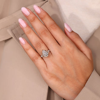 Muse setting ring featuring pear cut diamond with marquise side stones.
