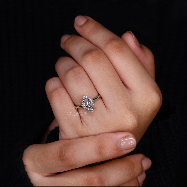 Halo Ring featuring a dazzling lozenge cut diamond center.