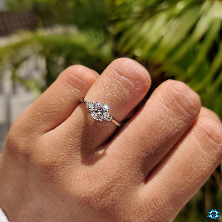 Classic moissanite engagement ring with four prong round stone setting.