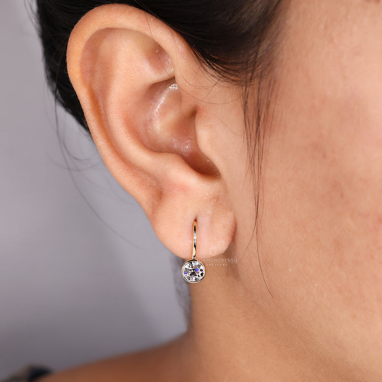 Bezel set diamond earrings for a sleek and secure design.