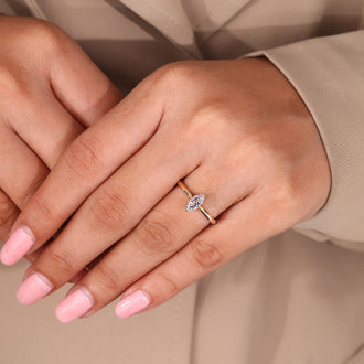 Solitaire engagement ring with a tulip setting and tapered shank.