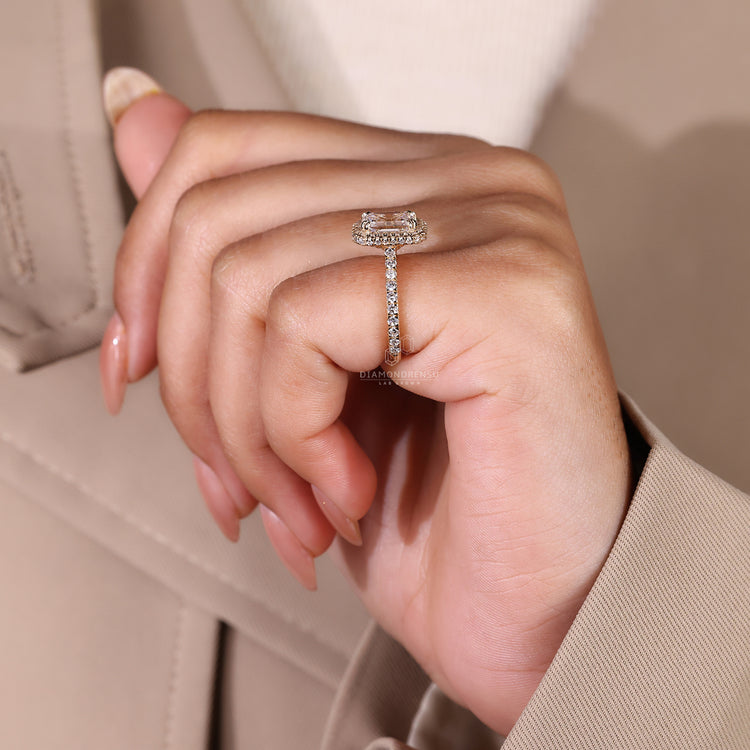 Yellow gold engagement ring with emerald halo design.