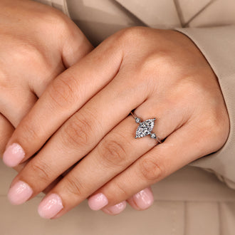 Buy diamond ring with marquise and round three stone arrangement.