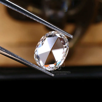 The loose diamond features an antique rose cut elongated cushion design.