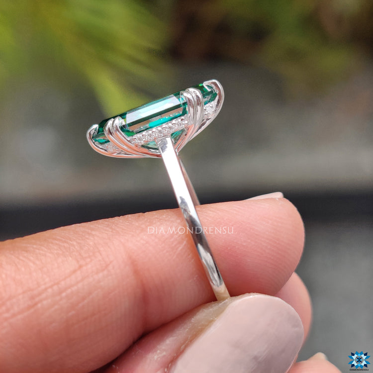 Handmade jewelry showcasing a green step cut Moissanite.