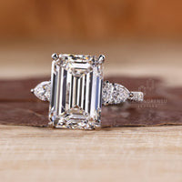 Three stone emerald cut diamond ring with tapered shank.