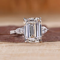 Handmade emerald cut diamond ring with four claw prong setting.