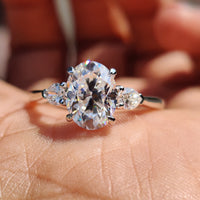 Oval engagement ring with pear side stones.