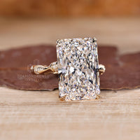 Radiant cut diamond ring with trellis setting and pave band.
