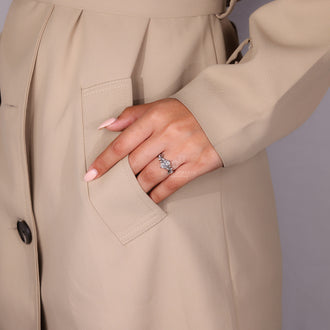 Marquise and round side stone accents add soft sparkle.