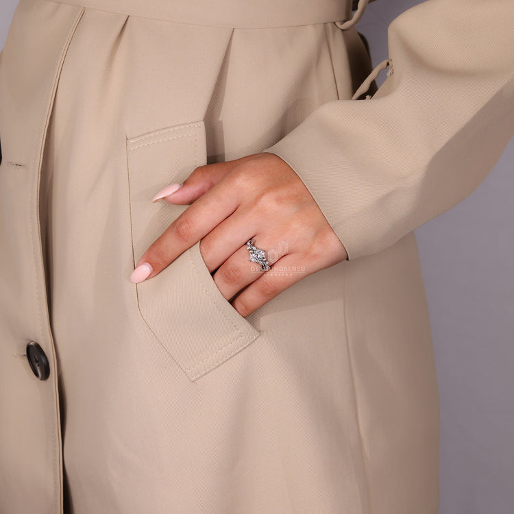 Marquise and round side stone accents add soft sparkle.