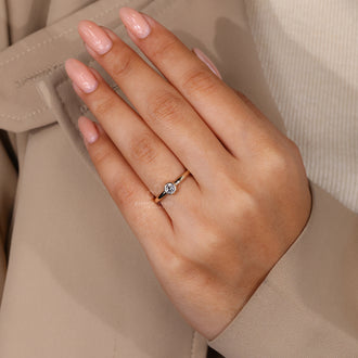 Brilliant cut diamond placed in a minimalist engagement ring design.