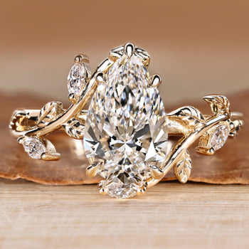 Pear cut engagement ring with nature inspired design.