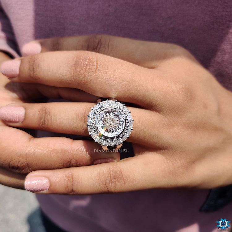 Vintage-inspired moissanite ring with a trillion cut center stone and an elegant halo design.