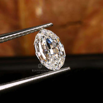 The loose diamond features a oval step cut design and is IGI certified.