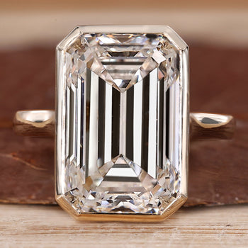 Bezel set emerald cut diamond ring.