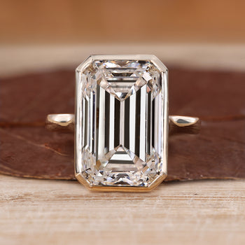 Bezel set emerald cut diamond ring.