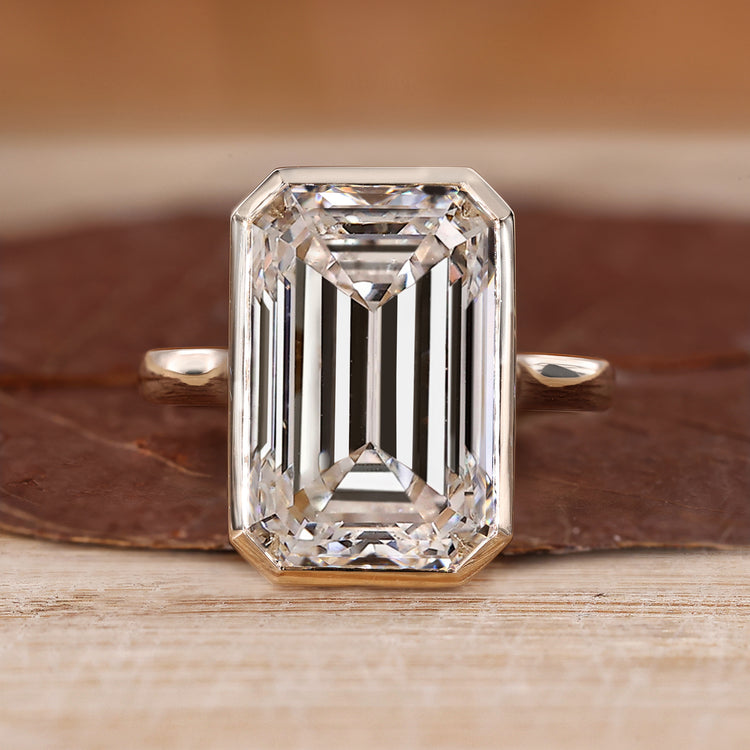 Bezel set emerald cut diamond ring.