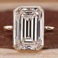 Bezel set emerald cut diamond ring.
