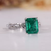 White gold ring featuring emerald birthstone with four prong setting.