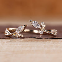 Nature inspired wedding band with marquise stone and open gap design.