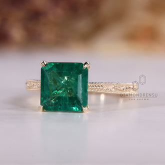 Asscher cut emerald ring with four claw prong setting.