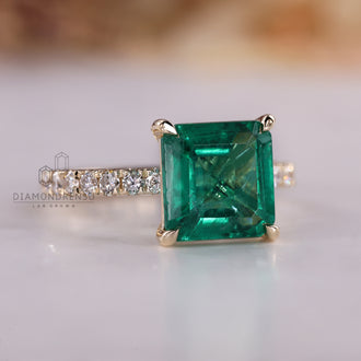 Pave setting emerald engagement ring.