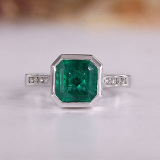 Asscher cut emerald ring in white gold.